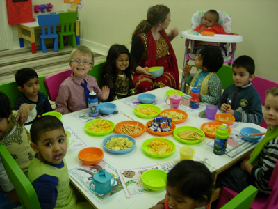 Pre-school children eating together at Early Learners' Nursery School, Leicester
